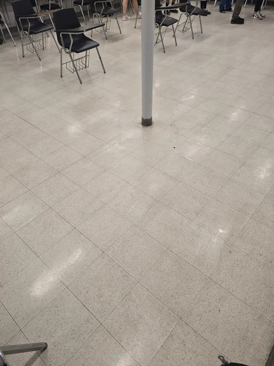 Commercial hard floor with chairs and desk stations.
