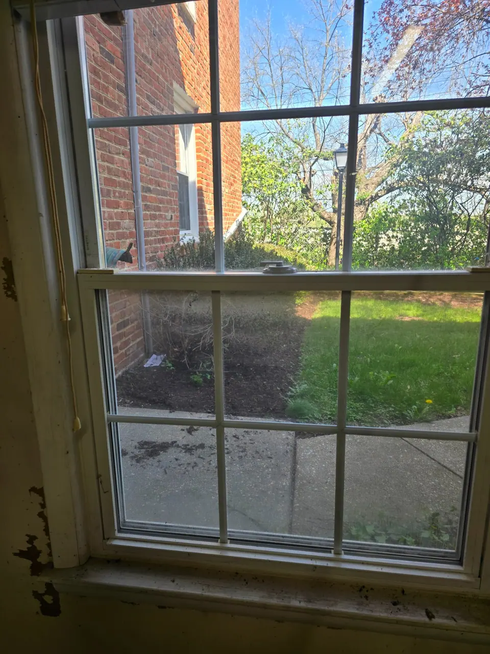 Interior window before cleaning, with visible buildup on the glass.
