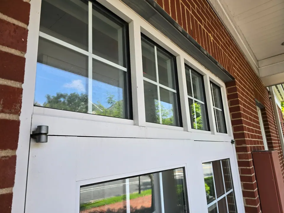 Clean upper window panels above commercial entrance doors.